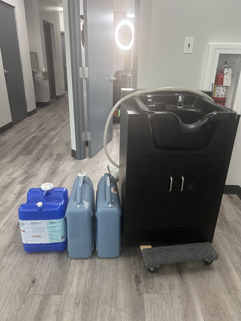 Portable shampoo bowl connected to clean and waste water jugs